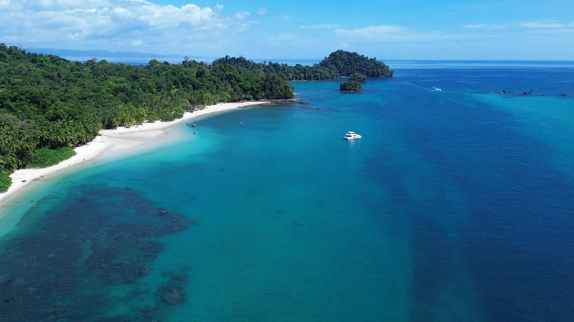 White-sand beach and turquoise water in Coiba National Park, from the air