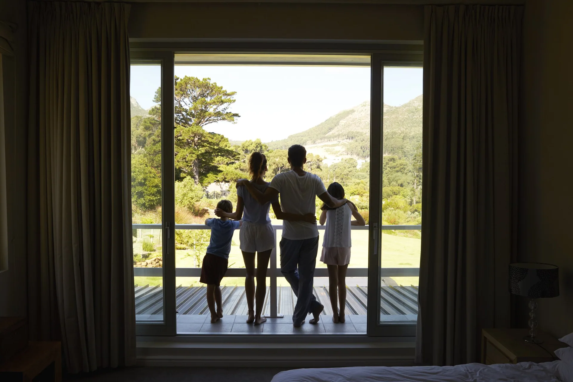 A family at the window of a hotel room in Panama